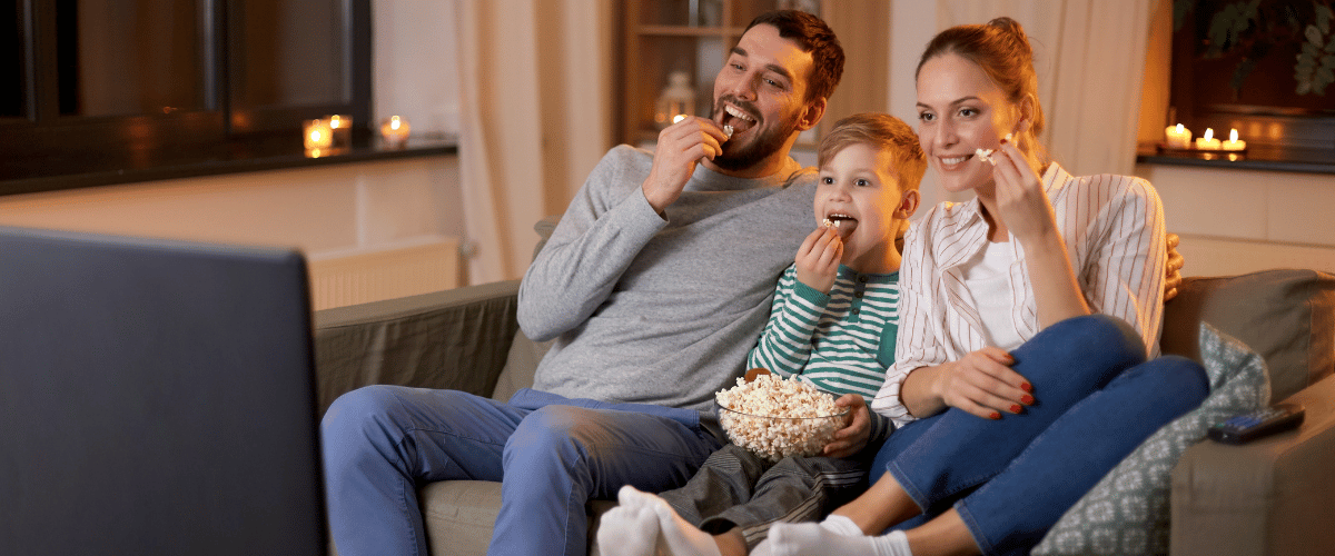 family watching tv eating popcorn